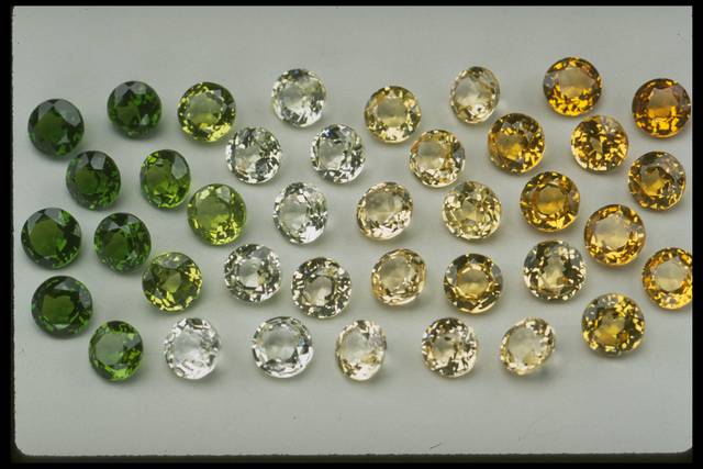 Photograph of a group of half-carat grossular garnets (NMNH G7918) from the National Gem Collection displaying a range of colors